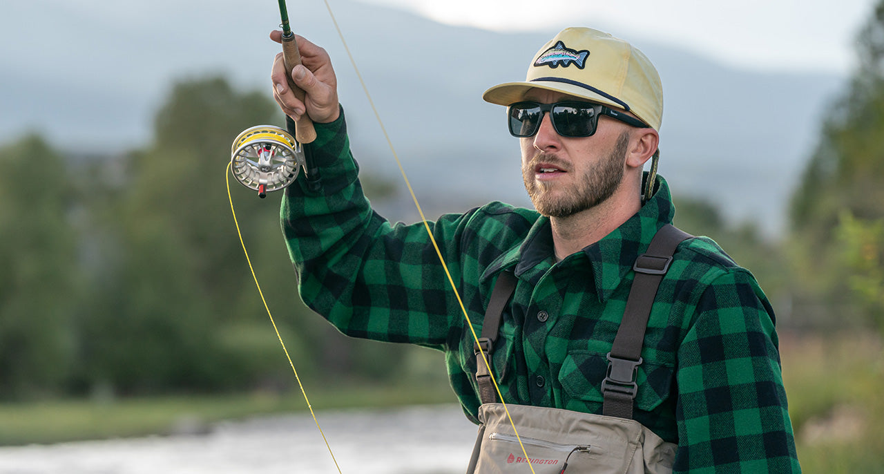man fly fishing wearing new updated plaid wool jacket 
