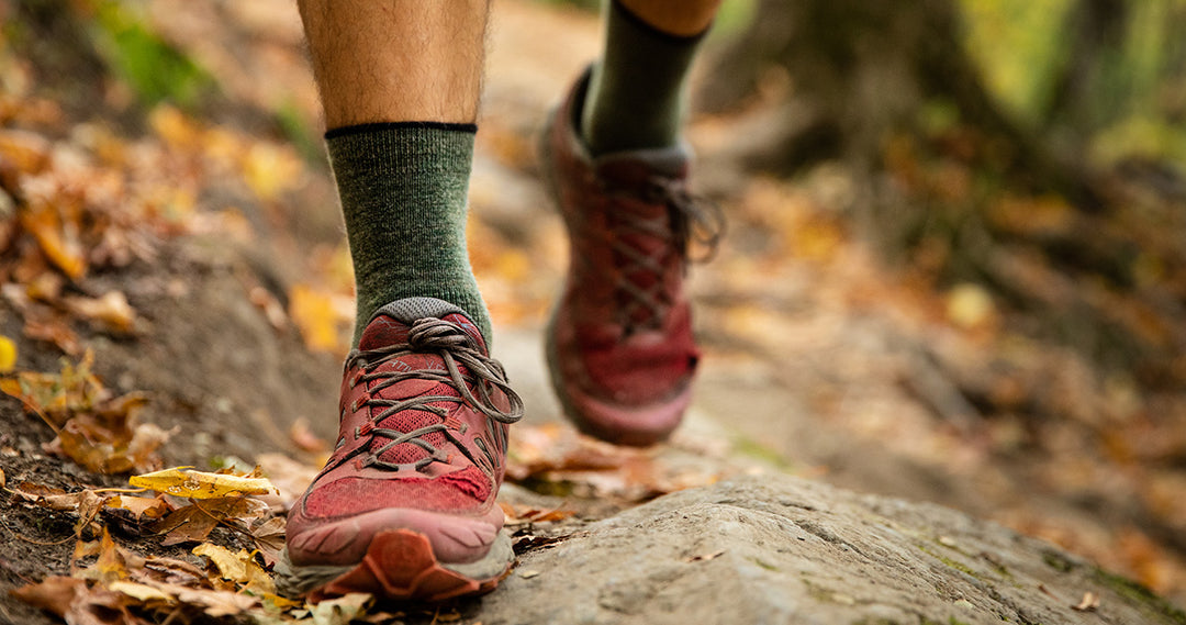 person running on the trails wearing mountain heritage socks
