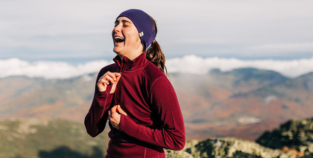 woman hiking wearing midweight merino wool in the fall